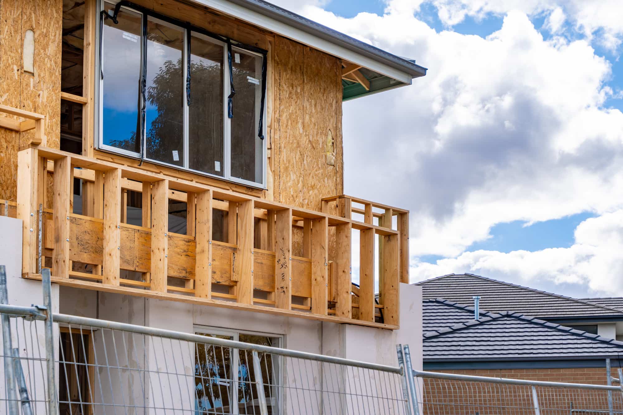 Dormer loft conversion under construction with timber framing and newly installed windows during a residential renovation project by Sunny Build in South West London.