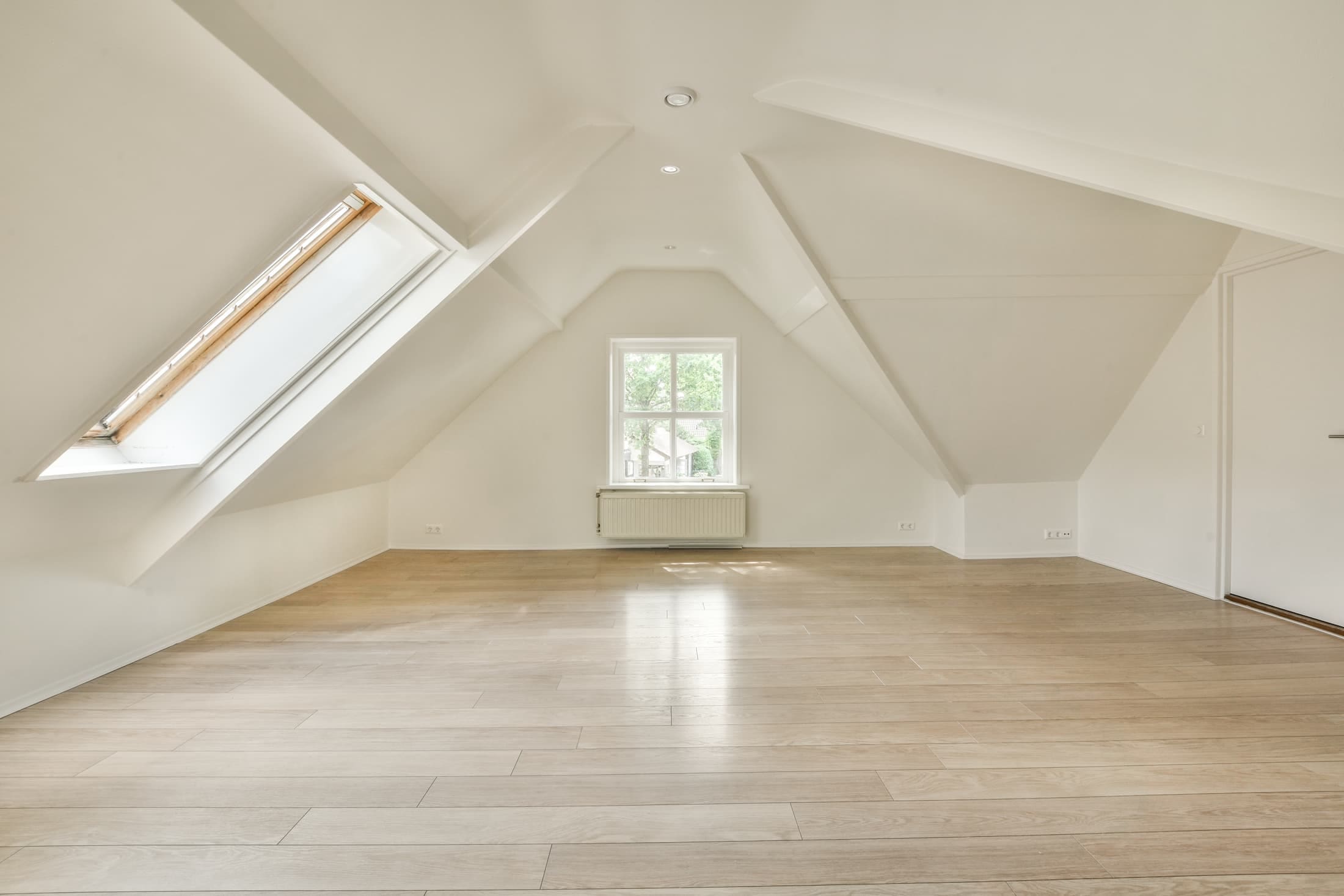 Bright loft conversion with vaulted ceilings, rooflight window and open-plan living space completed by Sunny Build in South West London.